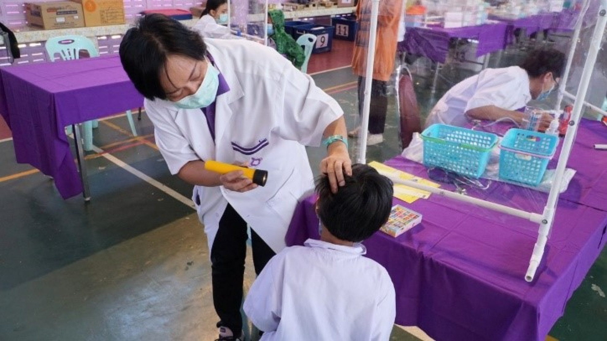 Doctors and dentists provided the physical examination and performed oral health assessment for students and local people.